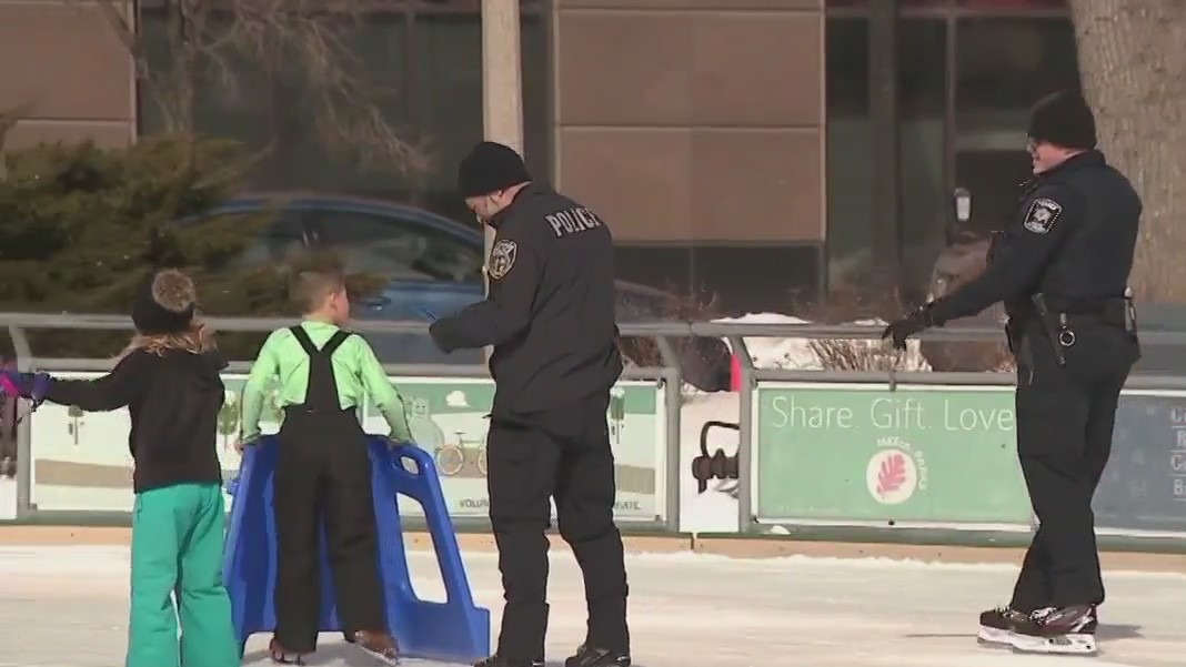 Milwaukee police, kids ice skate at Red Arrow Park